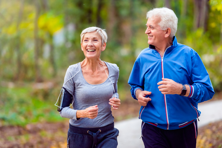 Senior active couple running, walking and talking in the park. Healthy lifestyle