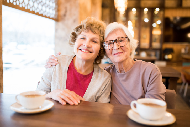cheerful-senior-women-friends-coffee-date