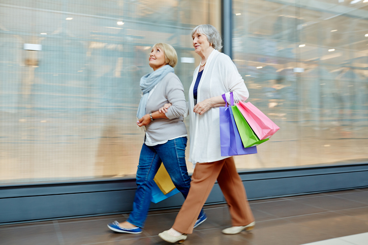 senior-women-walking-shopping-bags-mall