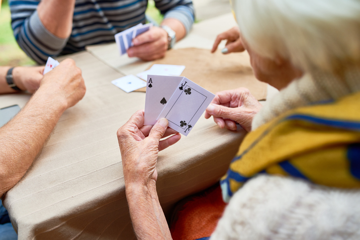 senior-woman-playing-cards-with-friends